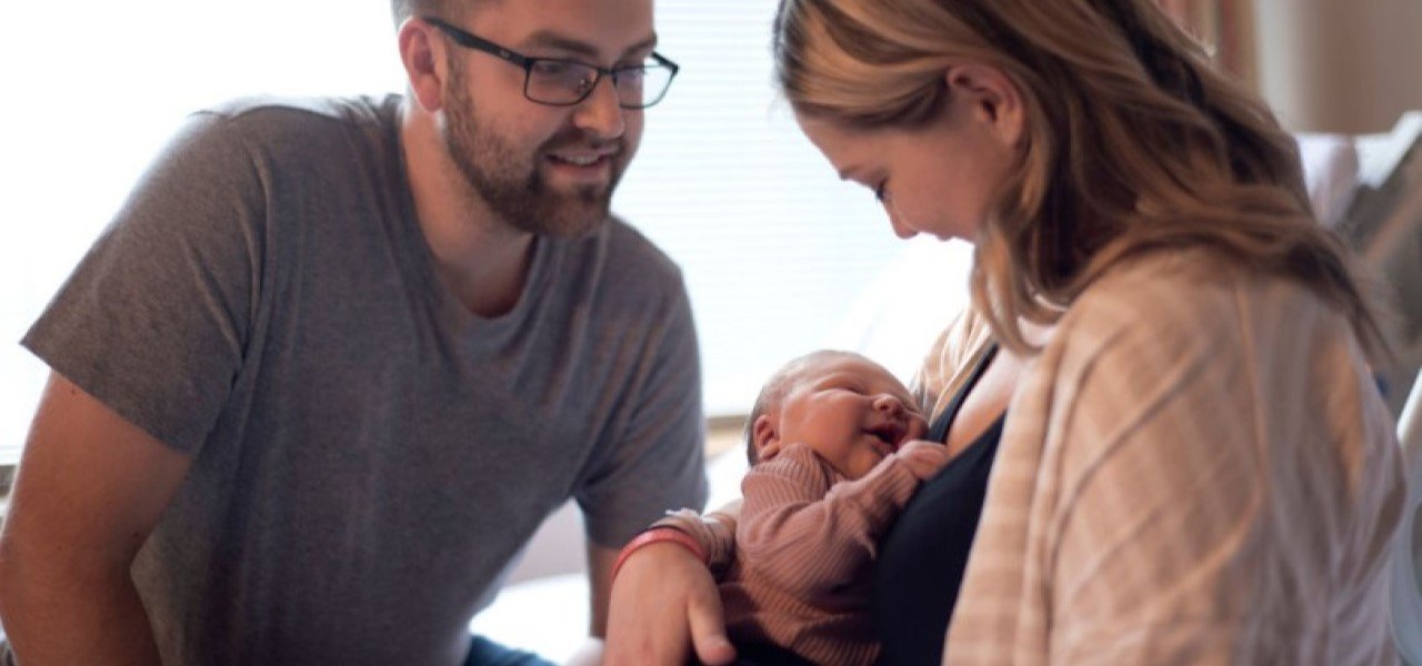 mother and father with newborn baby